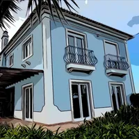A casa do Yoga Havelī, azul com janelas brancas e varandas de ferro
